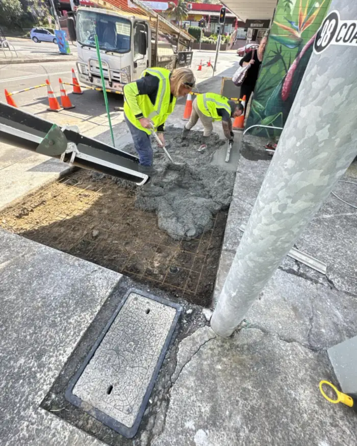 Concreting the footpath back around a new comms pit