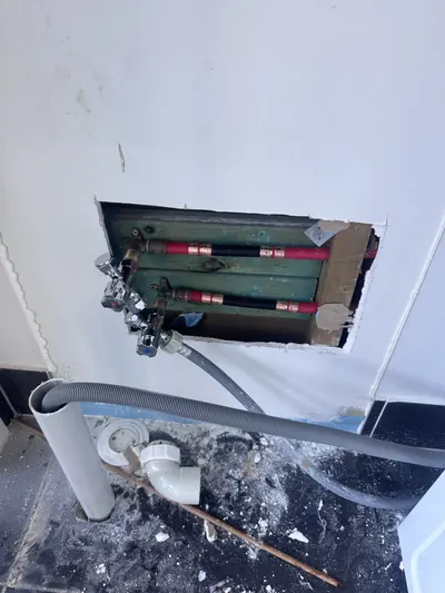 New hot and cold washing machine stops and the waste connection set at bench height, ready for the cabinet