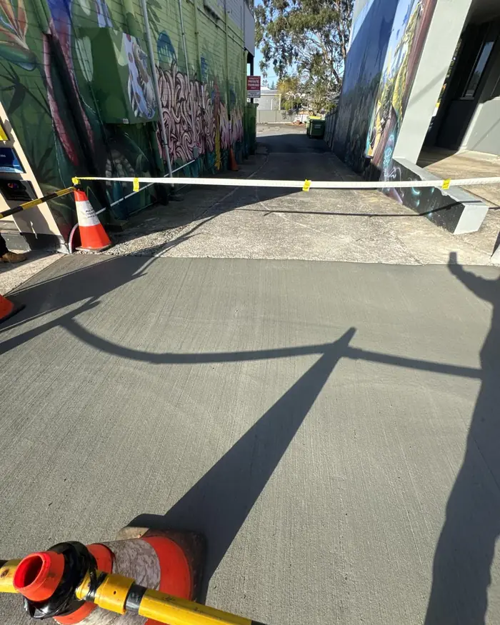 Footpath reinstated with fresh concrete after a conduit installation
