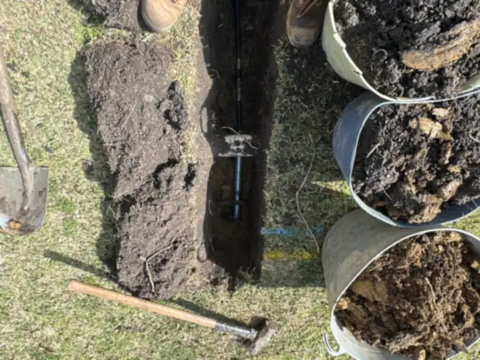 Grundomat pneumatic boring tool in its launch pit, boring under lawns, paths and driveways instead of digging a long trench