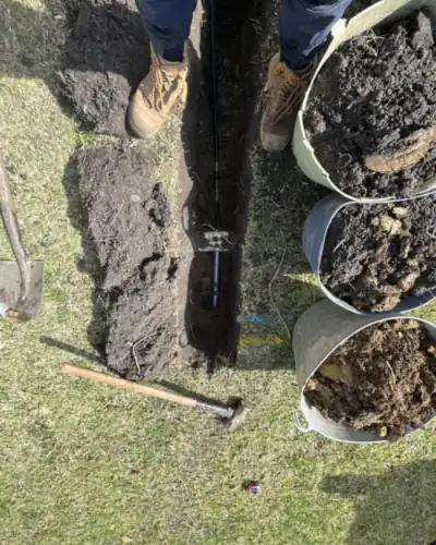 Grundomat pneumatic boring tool in its launch pit, boring under lawns, paths and driveways instead of digging a long trench