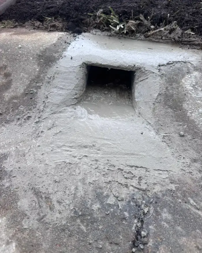 Stormwater kerb outlet cast into the gutter