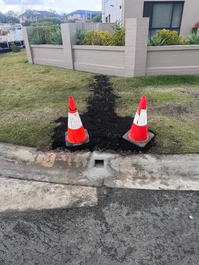 Finished: stormwater upgraded to steel pipe, kerb outlet cast, lawn topsoiled and ready for turf