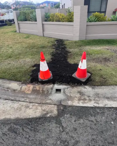 Finished: stormwater upgraded to steel pipe, kerb outlet cast, lawn topsoiled and ready for turf