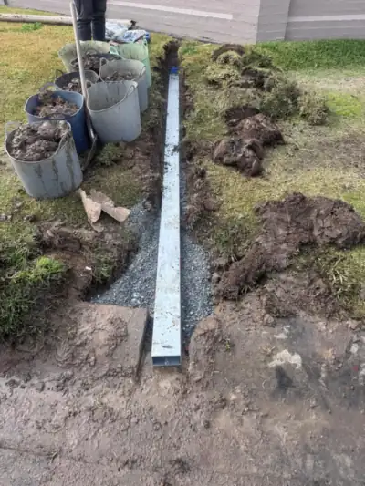 Stormwater upgraded to galvanised steel pipe running to the kerb, laid on gravel bedding
