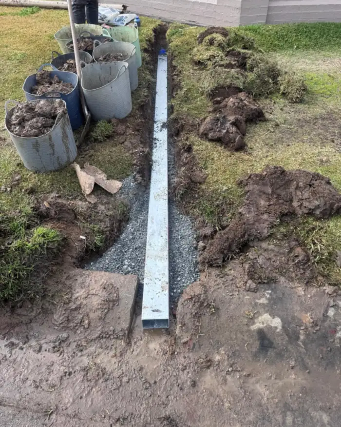 Stormwater upgraded to galvanised steel pipe running to the kerb, laid on gravel bedding