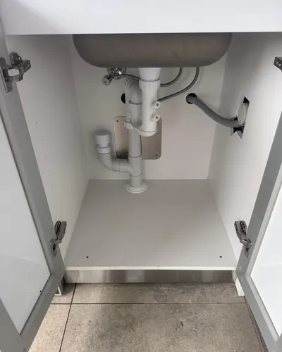 Tidy under-sink plumbing: trap, stop taps and dishwasher connection